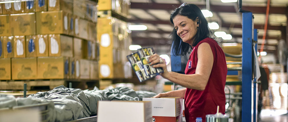 happy worker packing boxes wide