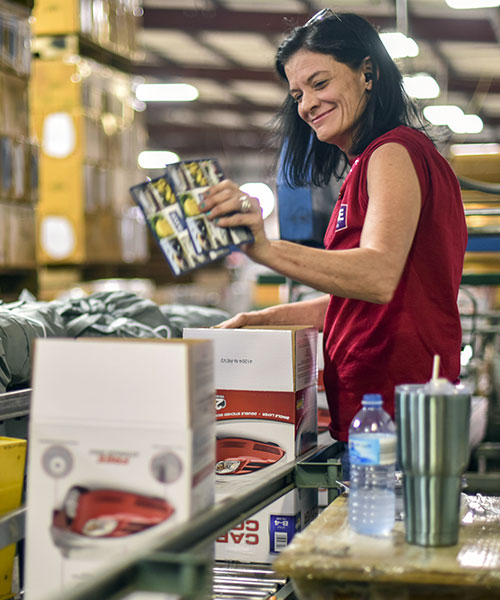 happy worker packing boxes